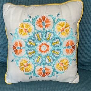 International Designs pillow with colorful embroidery, approximately 16” x 16”